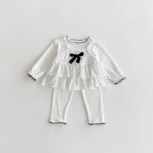 Sweet baby girl 3-piece set featuring polka dot camisole, ruffled long sleeve top and pants.