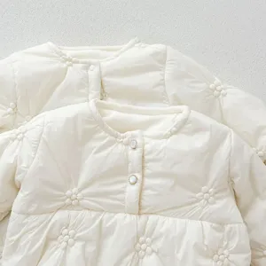 Detail view of infant baby cotton padded jacket set with cute floral quilting and buttons.