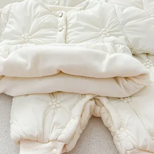 Creamy white baby winter quilted romper with floral embroidery and warm fleece lining cozy.