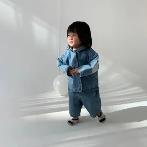 Close-up detail view of the stylish infant toddler denim jacket and pants clothing set.
