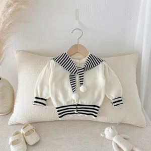 Infant baby knitted cardigan detail, cute sailor collar with pompom and stripes.