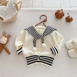 Close-up detail of infant knit cardigan featuring black and white striped sailor collar.