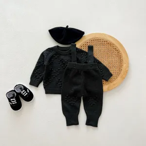 Infant black knit sweater and overalls set with cute hat and shoes for autumn and winter baby wear.