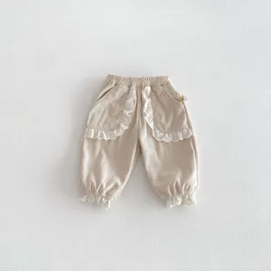 Cute toddler girls corduroy pants with delicate white lace ruffles, casual cuffed long trousers.