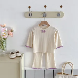 Infant baby girl ribbed thermal top flared pants set detail view, cute purple bow trim.