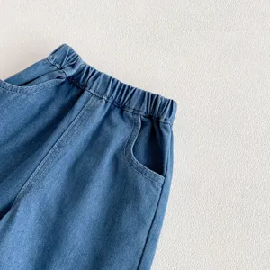 Kids denim jeans waist and pocket detail close up showing elastic waistband style.