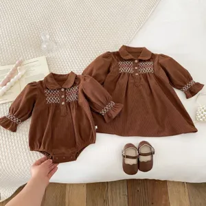 Cute baby girls corduroy dress and romper set with delicate smocked embroidery for autumn.