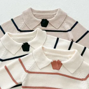Close-up detail of infant knit sweaters, featuring classic striped pattern and lapel collar design.
