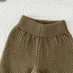 Primo piano dei pantaloni in maglia per neonati con vita elastica e consistenza.