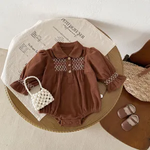 Cute infant baby girl brown corduroy romper with white embroidery and collar details.