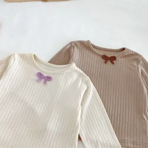 Cute baby long sleeve knit top featuring a delicate crochet bow detail, soft and comfortable.
