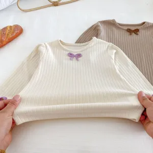 Infant baby girl ribbed long sleeve t-shirt detail showing soft knit fabric and cute bow decor.
