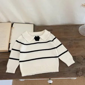 Baby striped knit sweater with lapel collar and cute black bow detail, cozy autumn wear.