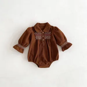 Brown corduroy baby romper detail, cute doll collar, smocked embroidery, long sleeves.