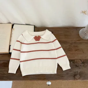 Cute baby knitted sweater with lapel collar and brown stripes. Soft toddler fall top.