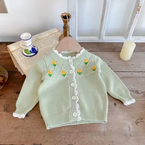 Infant baby green knit cardigan sweater with cute yellow floral embroidery and ruffles.