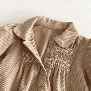 Corduroy baby dress detail, white and pink smocking embroidery, lapel collar, cute buttons.