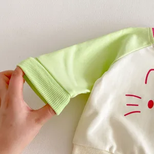 Close-up detail of children color-block sweatshirt cuff, soft fabric texture, cute design.