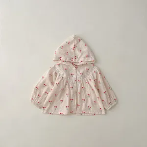 Detail van zomerse zonnebescherming vestje voor babymeisje, schattig kersjes print.