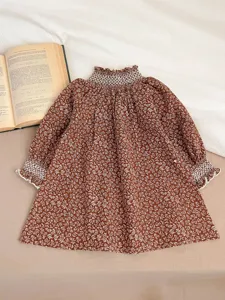 Infant baby girls brown floral long sleeve dress with smocked ruffled collar and cuffs detail.