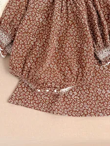 Infant baby girl brown floral romper detail, cute lace trim cuffs and bottom snap buttons.