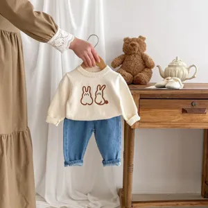 Charming baby knit sweater and denim pants set with cute bunny embroidery, cozy spring detail.