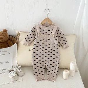 Detail shot of cute baby knitwear set featuring playful dot pattern, cozy home display.