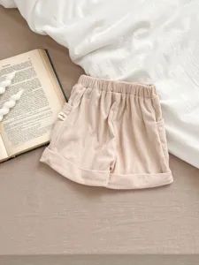 Infant corduroy shorts detail close up, elastic waist and cute rolled hem design for baby daily.
