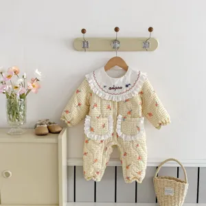 Charming baby quilted romper detail with floral pattern, cute ruffles, and warm design.