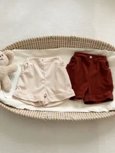 Corduroy baby shorts in beige and brown, featuring cute button and rolled cuff design details.