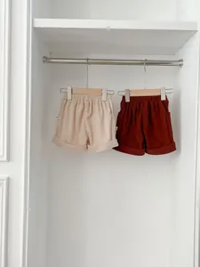 Detailed shot of infant corduroy shorts hanging in wardrobe, elastic waist, baby apparel.