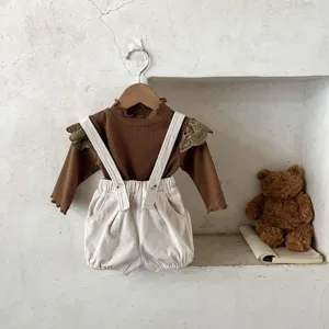 Infant corduroy overalls set, cute retro style baby long sleeve top and shorts detail view.