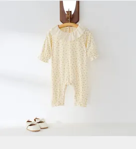 Detailed view of baby floral long-sleeve romper with frilly lace collar and cute cuffs.