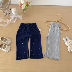 Joli pantalon évasé en coton pour bébé fille avec nœud et imprimé souriant, tendance.