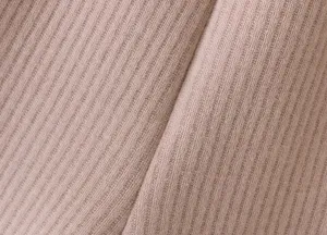 Close-up fabric texture detail shot of soft ribbed knit material, comfortable and stylish.