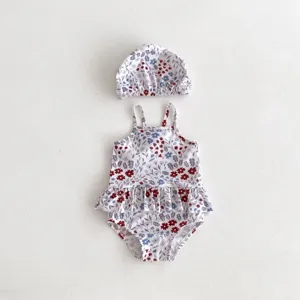 Cute baby girl floral one-piece swimsuit with matching hat, perfect for summer beach fun.