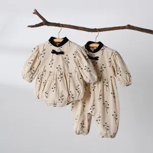 Detailed view of cute baby girl Chinese style floral romper and jumpsuit with mandarin collar.