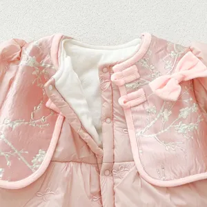Detailed view of baby winter padded coat, embroidery floral pattern and traditional Chinese knot.