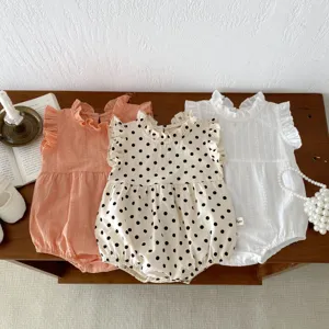 Infantry baby sleeveless romper detail showcasing ruffles, stand collar and cute polka dots design.
