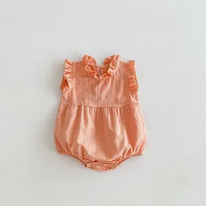Detailed view of infant summer sleeveless romper featuring ruffled collar and cotton texture.