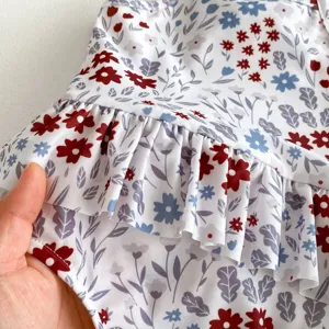 Close-up of toddler swimsuit floral fabric with cute ruffles, soft and quick-drying texture.