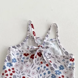 Close-up view of the floral print children swimsuit strap and back bow detail design.