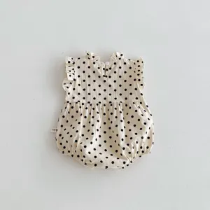 Infant baby girl cotton sleeveless romper with cute black polka dots and ruffles detail.