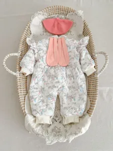 Detailed view of winter baby fleece-lined cotton romper with cute bunny ears and matching hat.