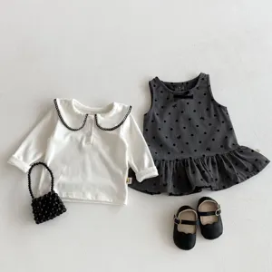 Fall baby girl clothing set featuring white long-sleeve top, grey polka dot dress, bag and shoes.
