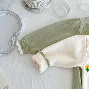Infant baby knitted cardigan romper with cute handmade flower embroidery, soft cotton material.