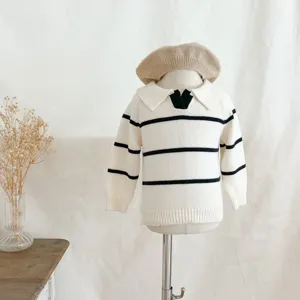 Infant baby knit sweater detail, classic black and white horizontal stripes, stylish lapel collar.
