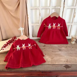 Detailed view of cute toddler girls red knit sweater dress featuring handmade embroidered rabbits.