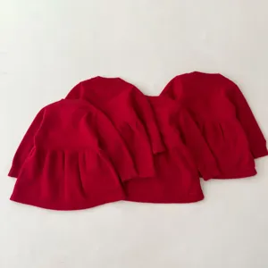 Detailed view of the red toddler knit dress back design, soft texture and cute ruffle hem.