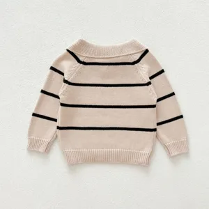 Detailed view of infant knit sweater, lapel collar with black and beige stripes design.